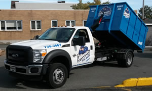 Dump Commander track delivering rental bin